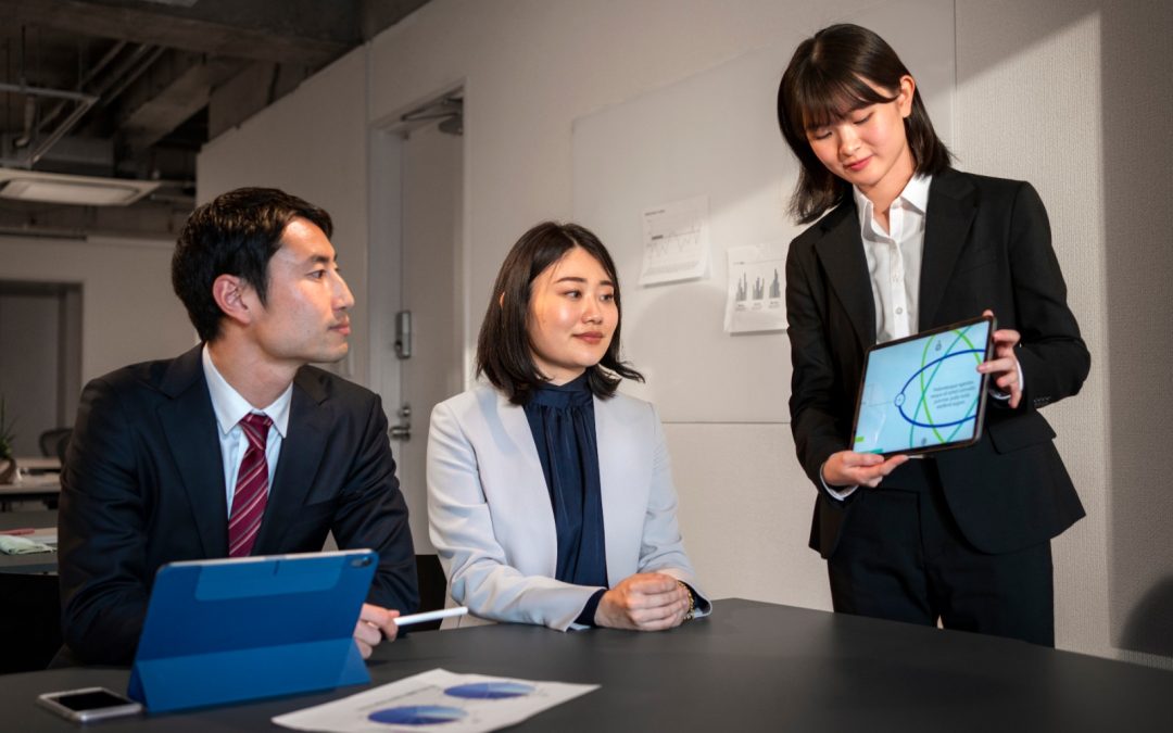 Business team reviewing financial data on tablet, illustrating Rational Pivot: China’s shift toward financial security.